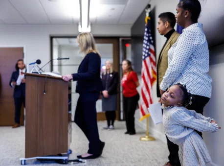 Kenzleigh Gresham, 3, stretches next to her mother, Alexis, during a press conference on Tuesday, March 3, 2026 at the General Assembly Building in Richmond, Virginia.